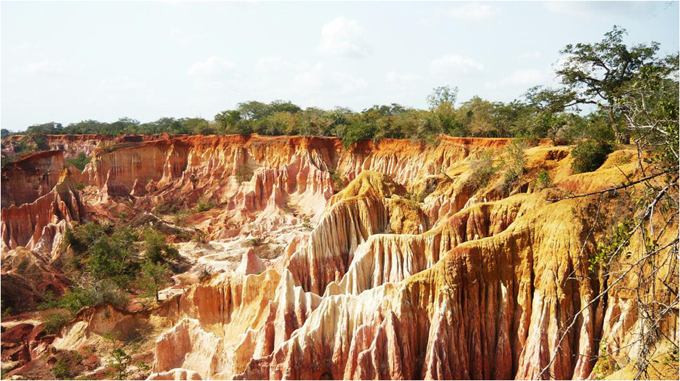 a picture of bright multicolored canyons of the Marafa Hell's Kitchen